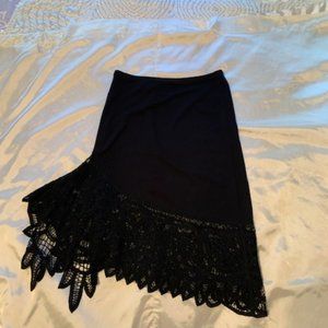 Black fitted skirt with asymmetrical lace hem